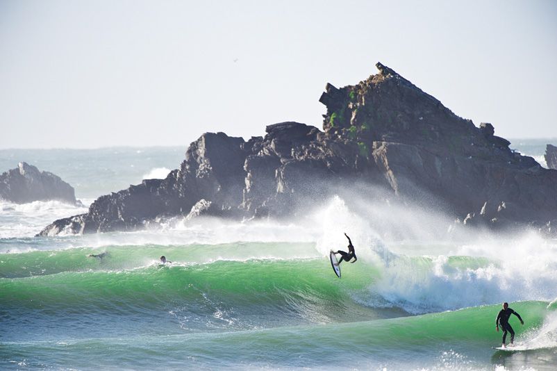 A surfer off the lip of a green wave at Broken Head, Byron Bay